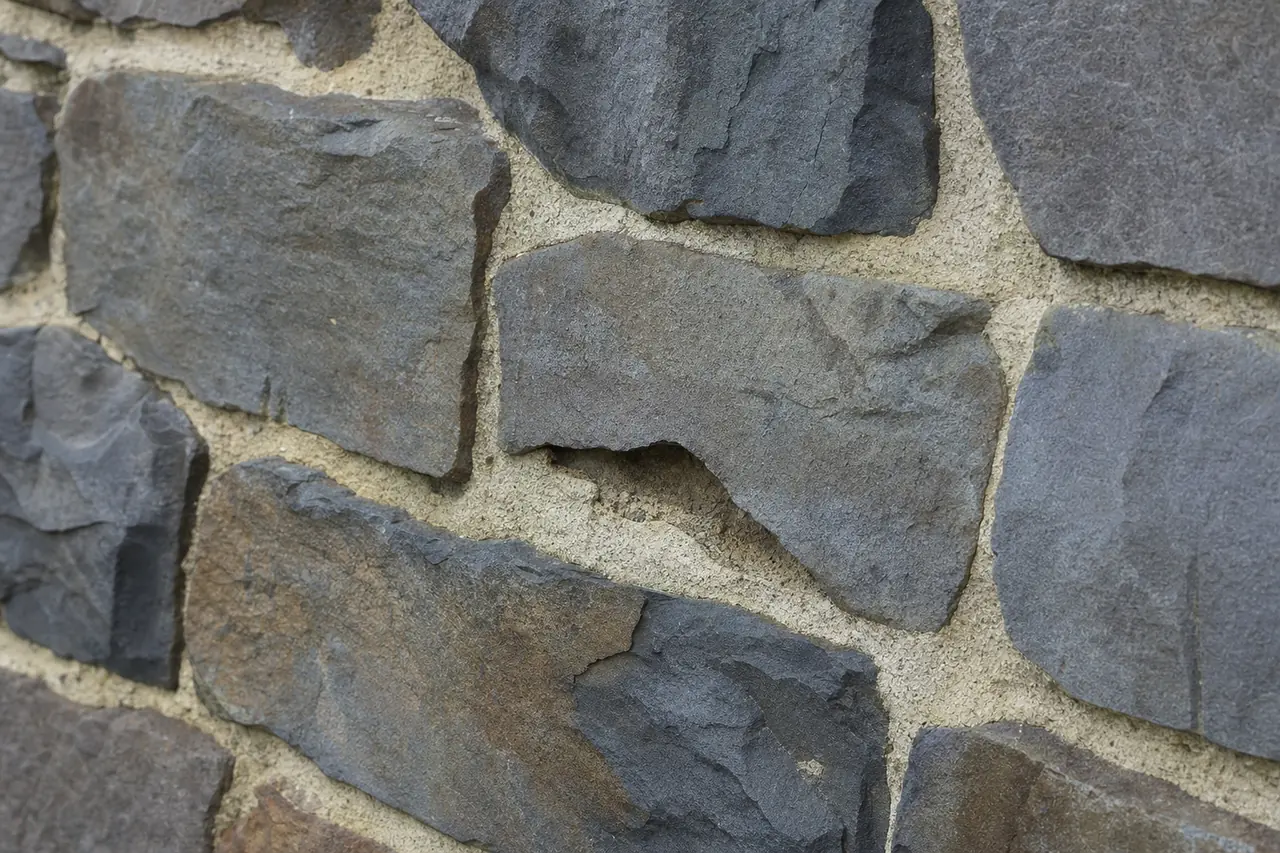 A close view of a bluestone wall with pale lime mortar joints — heritage masonry repair, Adelaide. Illustrative example.